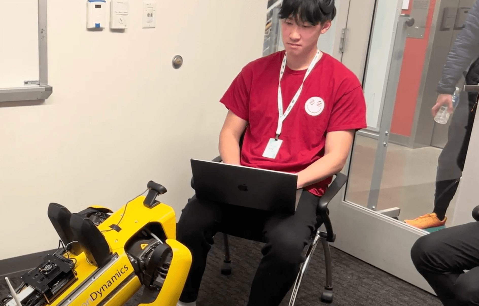 Robot Dog looking at  guy